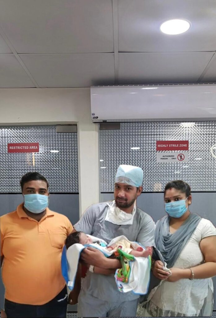 Happy parent holding a newborn baby at GHRACE & HOPE IVF representing a successful fertility treatment and parenthood journey.